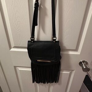 Women’s black and gold fringe side bag.